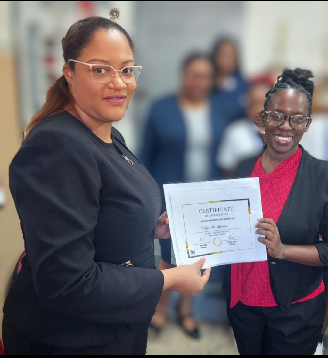Certificate presentation featuring Ms. De Coeau